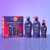 It's a 10 hair care product set with shampoo, conditioner, and packaging on a reflective surface with a purple gradient background.