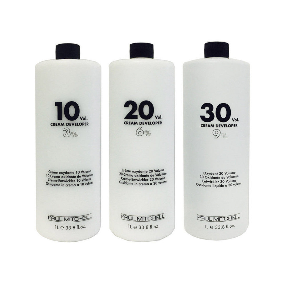 Three bottles of Paul Mitchell cream developers with different volumes on a white background
