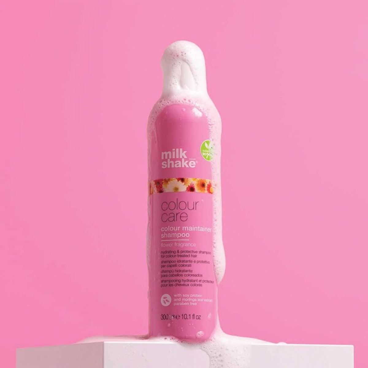 Pink shampoo bottle with 'milk_shake' branding on a pink background