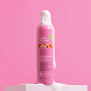 Pink shampoo bottle with 'milk_shake' branding on a pink background