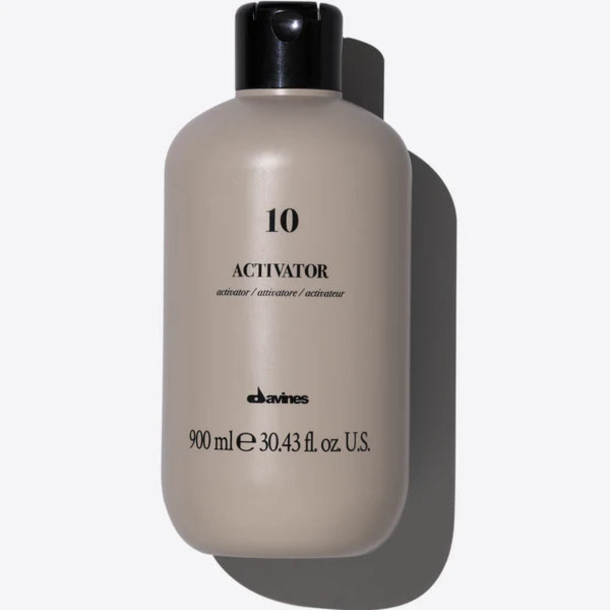 Beige bottle labeled 'Activator 10' with black cap on a white background