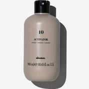 Beige bottle labeled 'Activator 10' with black cap on a white background