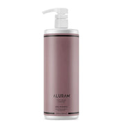 Shampoo bottle with pump labeled 'Aluram Clean Beauty Collection Daily Shampoo 33.8 oz' on a white background