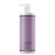 Purple shampoo bottle with pump labeled 'Aluram Clean Beauty Collection Purple Shampoo 33.8 oz' on a white background