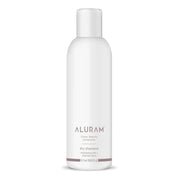 White bottle of Aluram dry shampoo on a white background