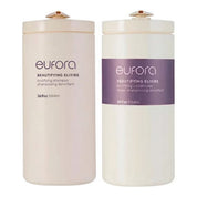Two cylindrical Eufora Beautifying Elixirs bottles on a white background, one containing bodyifying shampoo in a cream-colored container with a purple label, and the other containing bodyifying conditioner in a white container with a purple label.