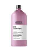 A 500ml bottle of L'Oréal Professionnel Liss Unlimited Professional Shampoo in a translucent pink bottle with a black cap, shown next to a black professional comb with metal teeth on a white background.