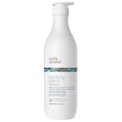 A 1000 ml white bottle of Milk Shake Purifying Blend Shampoo with a white pump dispenser, featuring a blue patterned band on the label.