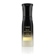 ORIBE Mystify Recyling Spray bottle, featuring a black cap and upper body with gold lettering, and a clear lower section showing the liquid inside, set against a plain white background with a subtle reflection.