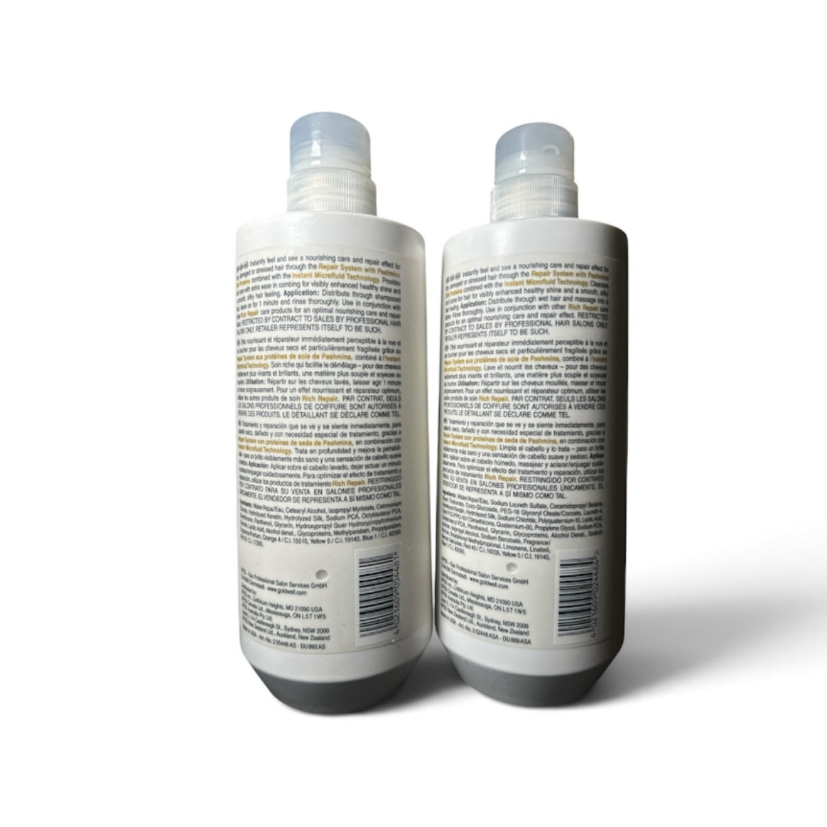 Two white plastic bottles with clear caps, showing the back labels, photographed on a white background with a soft shadow.