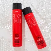 Two red bottles of Sexy Hair Big Boost Up Shampoo and Conditioner with black caps, set against a background of clear bubble wrap.