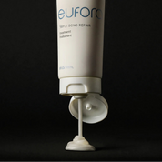 Eufora Triple Bond Repair treatment bottle with pump on a black background
