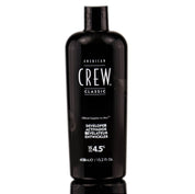 A bottle of American Crew Developer 15 Volume 4.5% in a black container with white and red label, 15.2 oz in size.