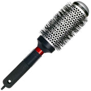 A round hot air brush from TechnoStyle, featuring a black handle, a red accent ring, a silver metal barrel with black bristles, and a silver cap, shown on a plain white background.
