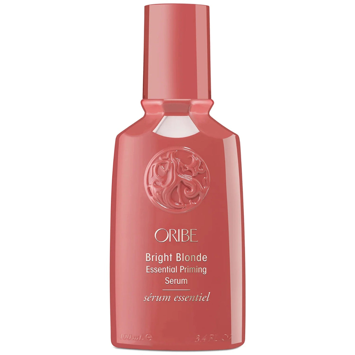 A bottle of Oribe Bright Blonde Essential Priming Serum in a glossy coral pink shade, shown against a plain white background.