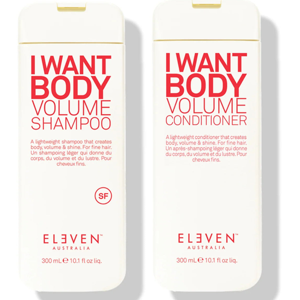 Two white plastic bottles of ELEVEN AUSTRALIA haircare products on a white background, labeled 'I WANT BODY VOLUME SHAMPOO' and 'I WANT BODY VOLUME CONDITIONER' in red and black text.