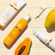 Milk Shake hair care products with a mango on a wooden surface
