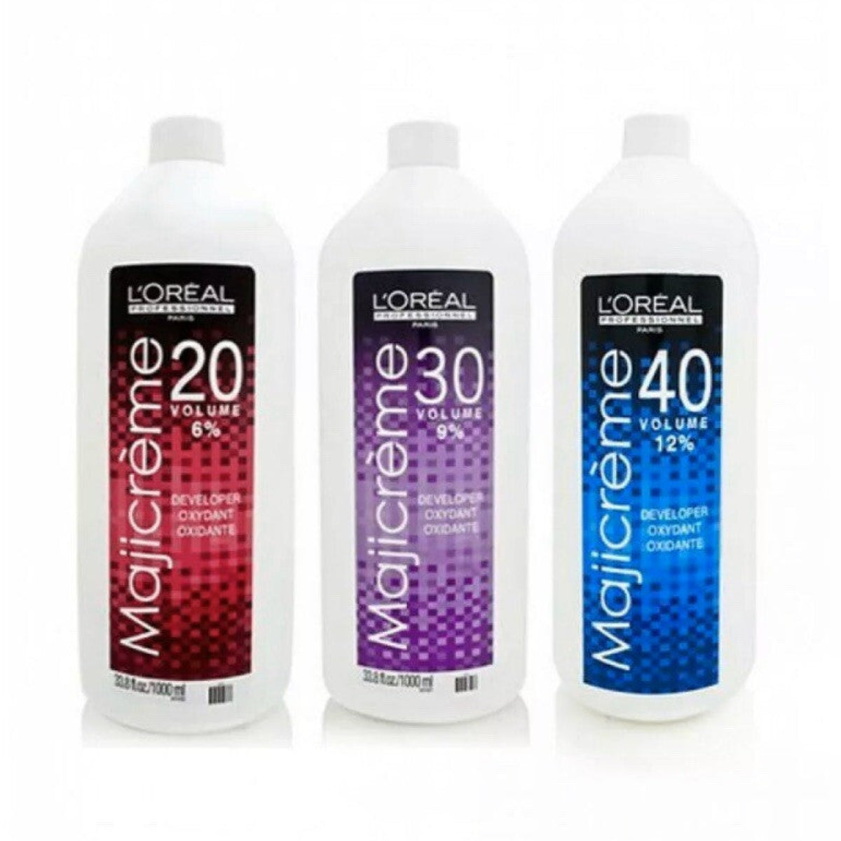 Three bottles of L'Oreal Majicreme hair color developer on a white background