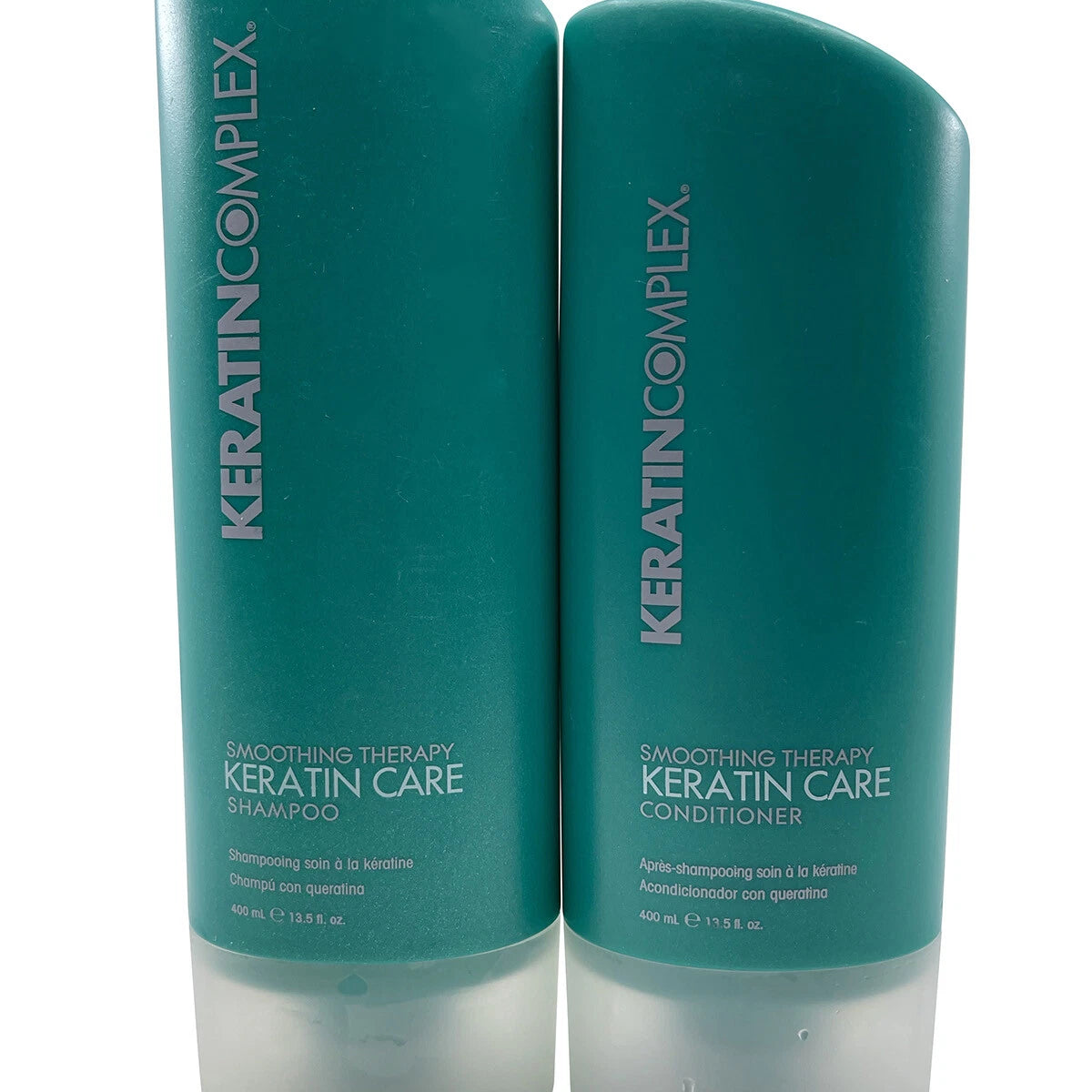 Two bottles of Keratin Complex Keratin Care Shampoo and Conditioner on a white background