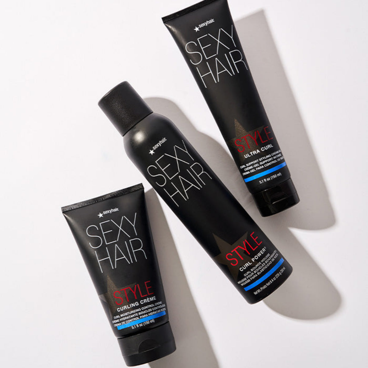 Three bottles of Sexy Hair products on a white background